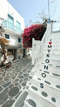 there is a white building with steps leading up to it and the words i love mykonos on them