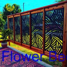 a wooden fence with the words flower box painted on it