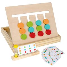 a wooden peg board with colorful buttons on it and matching cards in front of it