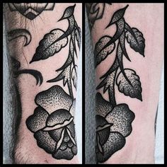 two black and white tattoos with flowers on their legs