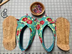 two pairs of shoes sitting on top of a cutting board