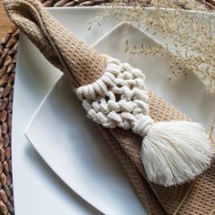 a white plate topped with a napkin covered in tassels