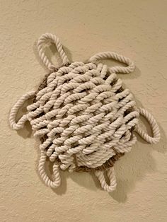 a white rope hanging on the wall