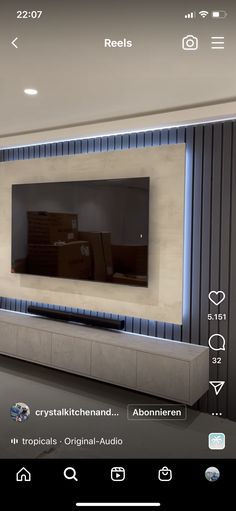 a large flat screen tv mounted to the side of a wall in a living room