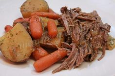 a white plate topped with meat, potatoes and carrots