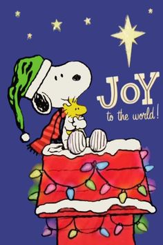 a snoopy christmas card with a dog on top of a present box and the words joy to the world