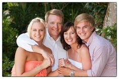 four people are posing for a photo together