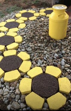 yellow and black stones are arranged in the shape of hexagons