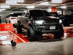 a black truck parked in a parking garage