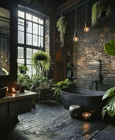 a bath tub sitting next to a window in a room filled with potted plants