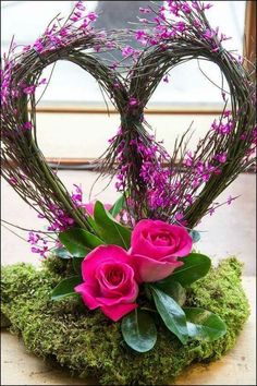 valentine's day flower arrangement with pink roses and greenery in the shape of a heart