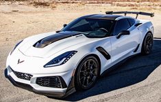 a white sports car parked in the desert