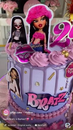 the birthday cake is decorated with pink icing and pictures of barbie dolls on it