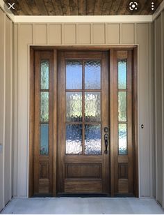 a wooden door with glass panels on the side