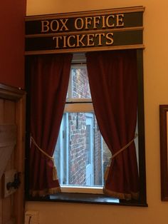 a window with a sign that says box office ticket's in front of it