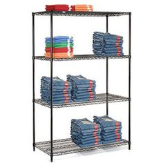 four tier shelving unit with blue towels and orange napkins on the bottom shelf