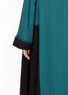 Wrap yourself in elegance with our Two Tone Open Abaya. This stunning color-blocked piece combines a rich green with stark black, creating a sophisticated and exclusive look. The loose modest silhouette is perfect for pairing with our slip dresses. Delicate lace trims on the sleeves add a touch of elegance. Model is 5'8 inches tall and wears size XS in length 58 inches 100% Viscose Item colour is Green & Black Hand wash or dry clean Hijab Caps, Botanical Collection, Slip Dresses