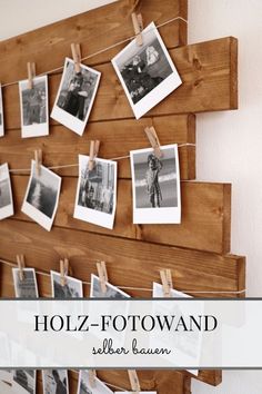 a wooden wall hanging with photos and clothes pins