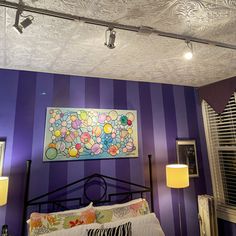 a bedroom with purple walls and white ceiling