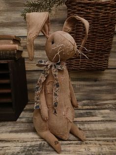 a brown stuffed animal sitting on top of a wooden floor