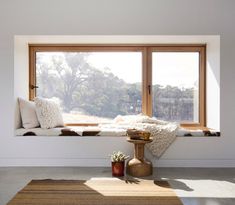 a living room filled with furniture and windows