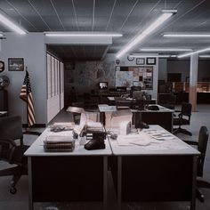 an office filled with lots of desks and computer monitors on top of them next to each other