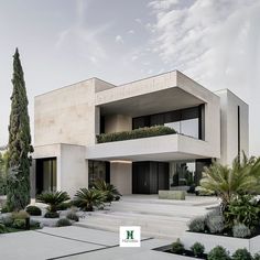 a modern house with trees and plants in the front yard