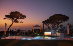 an illuminated pool in front of some trees