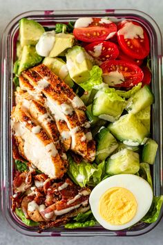 cobb salad meal prep with chicken, lettuce and hard boiled egg on the side