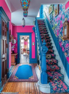 the hallway is painted bright pink and blue