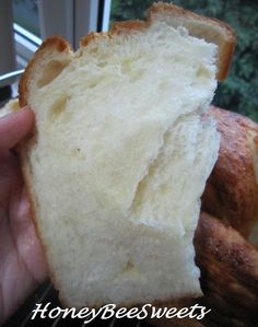 a person holding a piece of bread in their hand