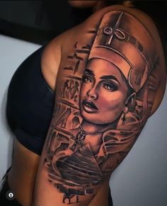 a woman's arm with an egyptian tattoo on it