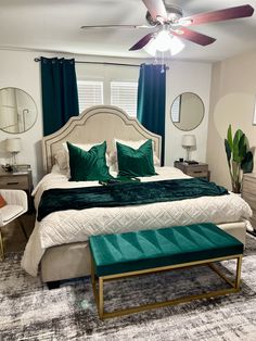 a bedroom with a large bed and green pillows