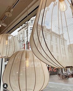 three lamps hanging from the side of a building