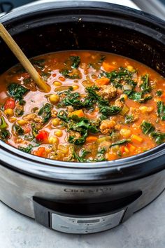 a slow cooker filled with soup and vegetables