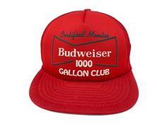 a red hat with the budweiser 100 gallon club on it's front