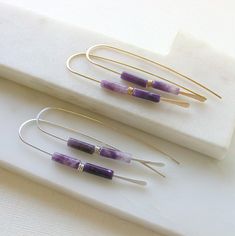 Minimalist and modern earrings featuring polished amethyst stones. Available in sterling silver and 14k gold fill. Earrings measure approximately 3". Luxury Gemstone Linear Earrings As Gift, Minimalist Purple Drop Earrings, Modern Gemstone Hoop Earrings For Everyday, Minimalist Purple Earrings With Ear Wire, Minimalist Nickel-free Purple Jewelry, Minimalist Purple Jewelry For Everyday, Minimalist Everyday Purple Jewelry, Purple Minimalist Earrings For Pierced Ears, Purple Minimalist Pierced Earrings