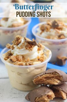 some desserts are in small plastic cups on a table with the words butterfingerer pudding shots