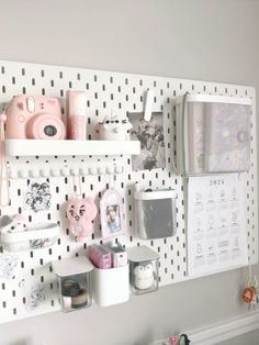 a white pegboard with various items on it