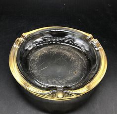 an antique silver and gold plate on black tablecloth with the lid open to show it's interior