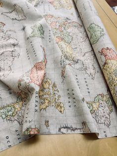 an old world map is laying on top of a table