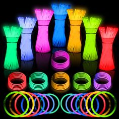 glow in the dark bracelets and rings are shown with neon colors on black background