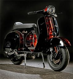 a black and red scooter is parked in the dark