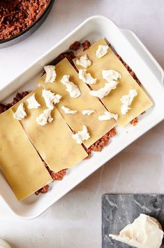 some food is laying out on a white tray and next to it are other foods