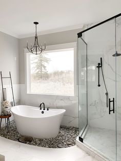 a white bath tub sitting next to a window