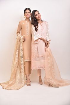 A rich tone of deep beige cotton net with hand sheesha work, paired with a delicate embroidered dupatta and matching raw silk trousers, revamp your wardrobe with this gorgeous three piece. Delivery Time: 6-8 weeks Beige Raw Silk Sets With Dabka Details, Beige Raw Silk Dabka Sets, Elegant Cambric Sharara With Zari Work, Beige Dabka Raw Silk Set, Cambric Salwar Kameez For Wedding, Designer Beige Sets For Eid, Beige Designer Wear Sets For Eid, Beige Designer Sets For Eid, Festive Beige Lace Work Sets