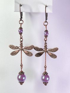 Long Victorian style Dragonfly Earrings with purple Czech glass pearls all done in Antiqued Brass Plated Copper. The earrings are just under 3 inches long. All purchases come with a gift box. Dragonfly Earrings, Victorian Style, Diy Earrings, Victorian Fashion, Cute Jewelry, Czech Glass, Jewelry Earrings Dangle, Beaded Jewelry, Etsy Earrings