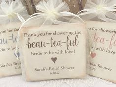 three small bags with wedding favors in them