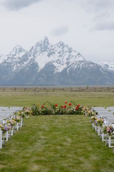 The Grand Teton Mountains lay behind a wedding ceremony with a floral ground installation and aisle of spring flowers. Colorado Wedding Ceremony, Montana Outdoor Wedding, Jackson Hole Wyoming Wedding Venues, Simple Colorado Wedding, Wyoming Wedding Jackson Hole, Wedding In Glacier National Park, Elope Jackson Hole, National Parks To Get Married In, Wedding In Wyoming