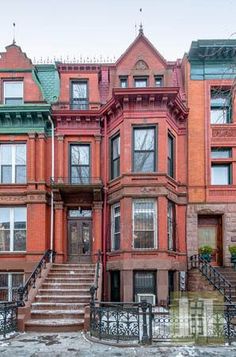 an old brick building with many windows and stairs